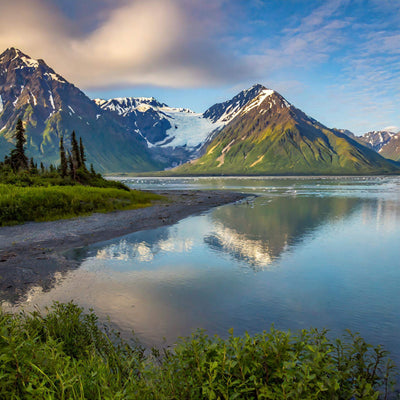 Crystal-clear lake surrounded by snow-capped mountains at Lake Clark National Park, Alaska