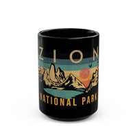 Black ceramic mug featuring a design of Zion National Park with mountains and a sunset.