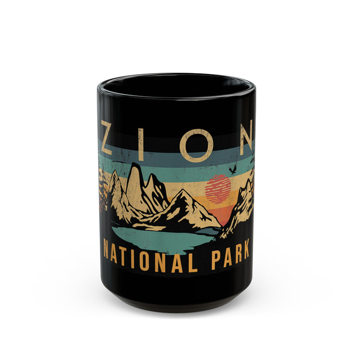 Black ceramic mug featuring a design of Zion National Park with mountains and a sunset.