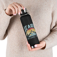 Stainless steel water bottle featuring an Acadia National Park design with a mountain and sunset illustration, durable powder-coated finish.