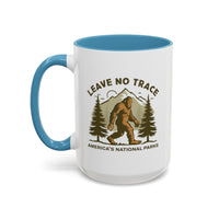 15 oz light blue Bigfoot souvenir mug with "Leave No Trace" text, trees, and mountains in the background, from America's National Parks.