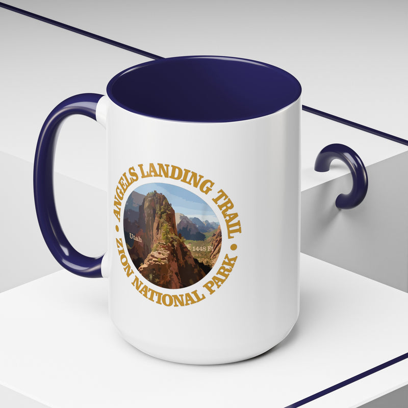 White ceramic mug with a contrasting handle and interior, featuring an image of Angels Landing Trail in Zion National Park with a mountain landscape design.