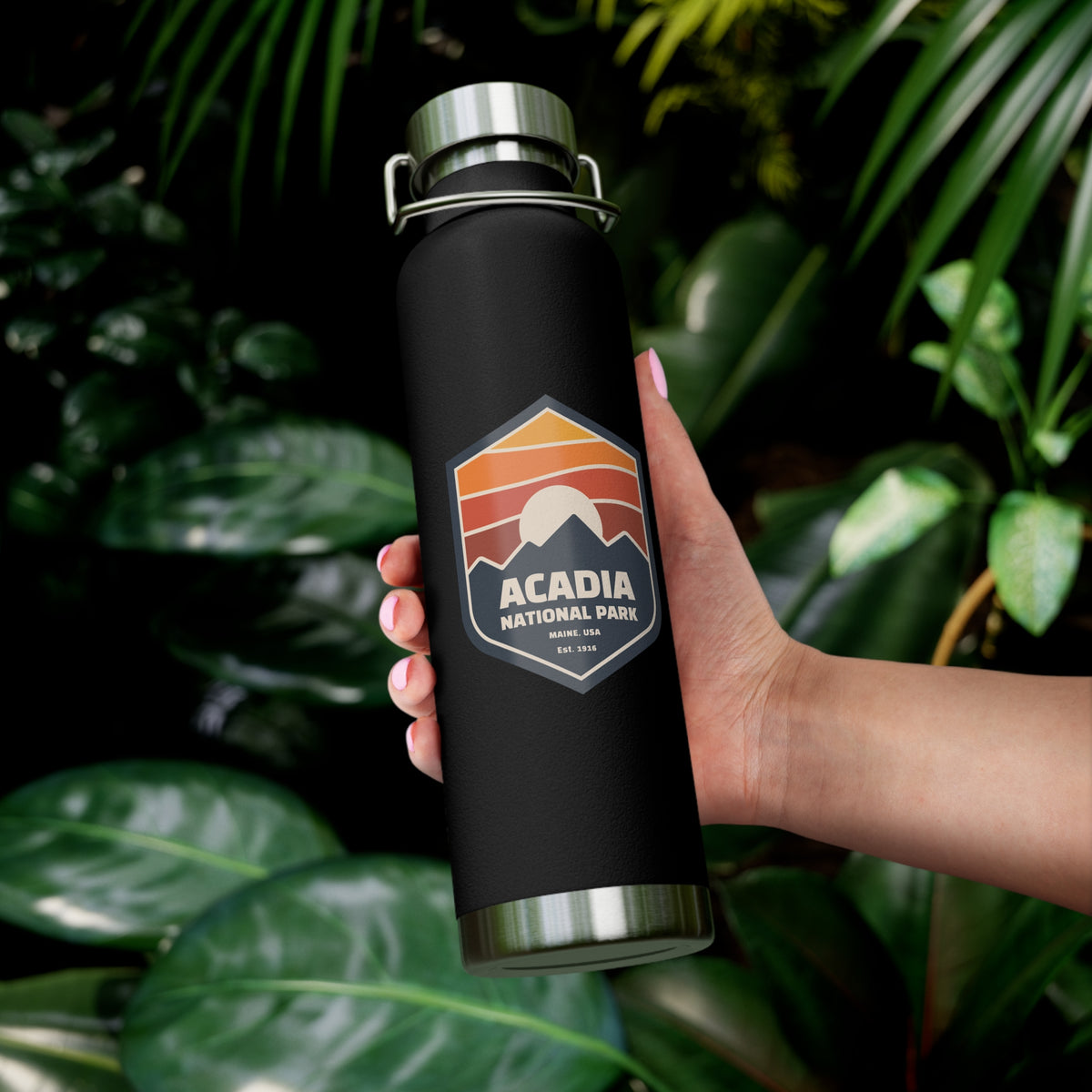 Stainless steel water bottle featuring an Acadia National Park design with a sunset badge illustration, durable powder-coated finish.