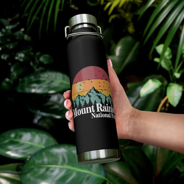 Stainless steel water bottle featuring a Mount Rainier National Park design with a sunset and mountain illustration, durable powder-coated finish.