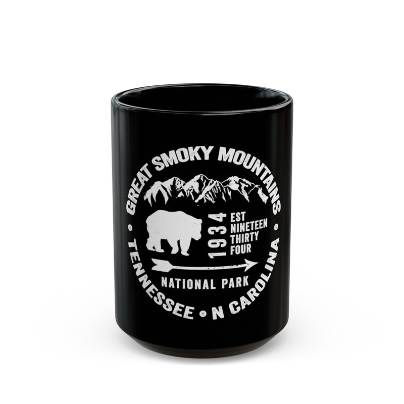 Ceramic mug featuring an illustration of Great Smoky Mountains National Park with a bear and mountains, including Tennessee and North Carolina locations.