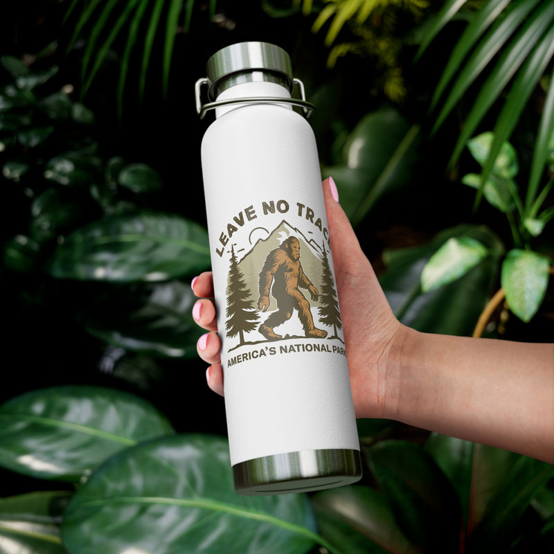 Water bottle featuring a Leave No Trace design with a bear, trees, and mountains, promoting conservation in America's national parks.