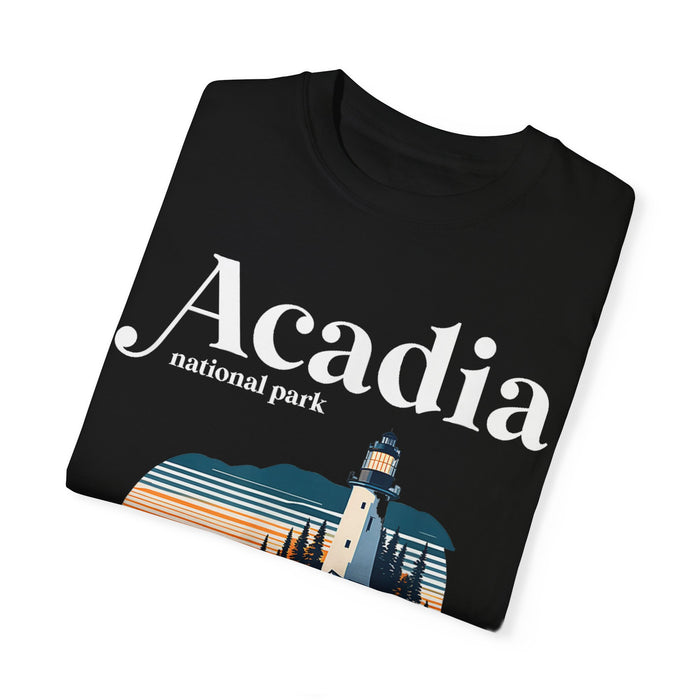 Acadia National Park T-shirt featuring a graphic design with a lighthouse, rocky cliffs, and sunset, with "Acadia" text.