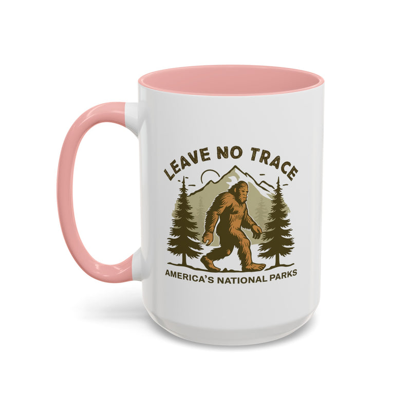 15 oz pink Bigfoot souvenir mug with "Leave No Trace" text, trees, and mountains in the background, from America's National Parks.