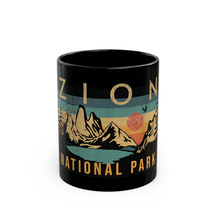 Black ceramic mug featuring a design of Zion National Park with mountains and a sunset.