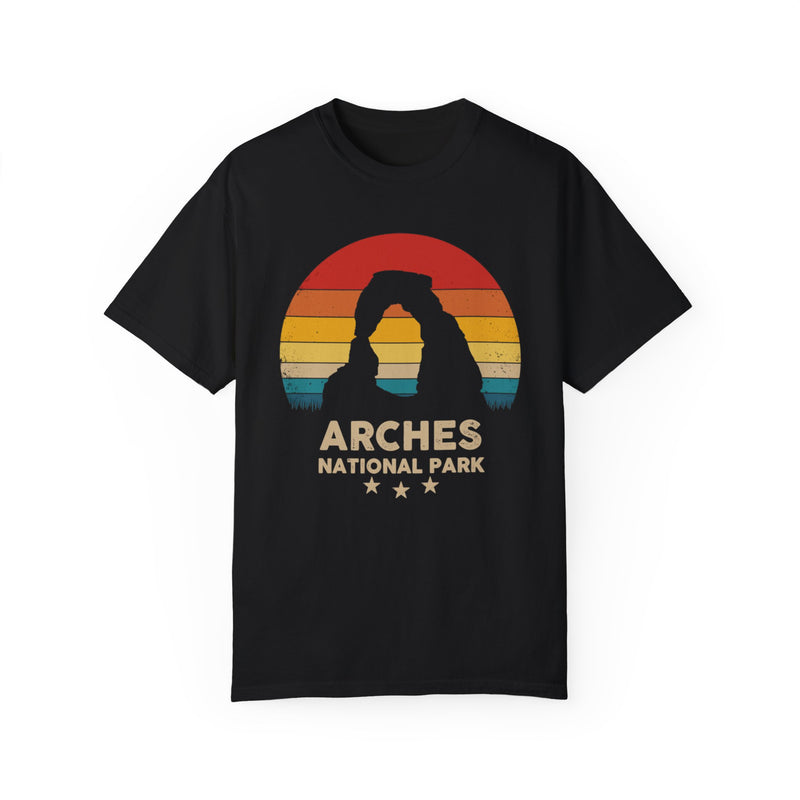 T-shirt featuring a scenic design of Arches National Park in Utah with a prominent arch and sunset background.