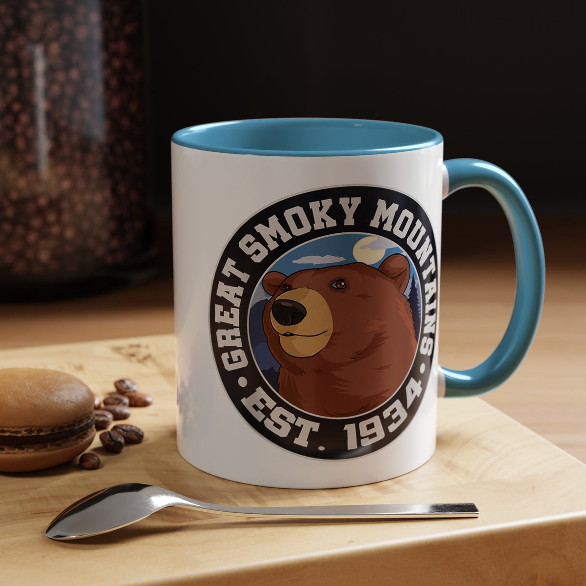 11 oz light blue ceramic mug featuring an illustration of a bear with the text "Great Smoky Mountains Est. 1934."