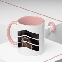 11 oz ceramic mug with pink handle featuring a mountain design with three chevrons, representing Arches National Park.