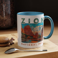 White ceramic mug with a contrasting handle and interior, featuring a scenic landscape design of Zion National Park.