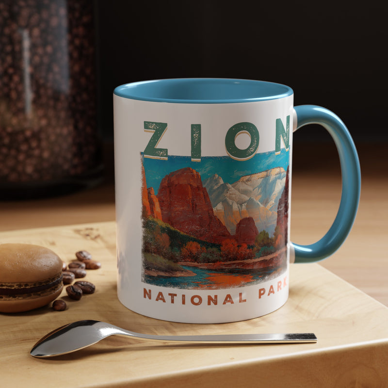 White ceramic mug with a contrasting handle and interior, featuring a scenic landscape design of Zion National Park.