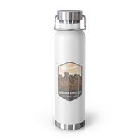 White stainless steel water bottle featuring a design of Theodore Roosevelt National Park with scenic rock formations.