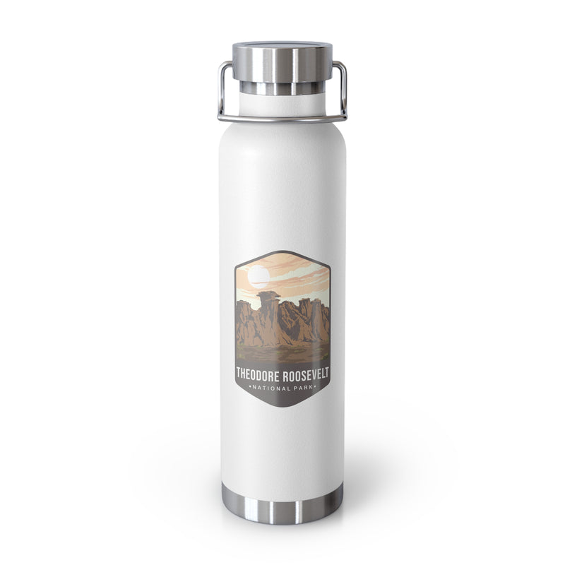 White stainless steel water bottle featuring a design of Theodore Roosevelt National Park with scenic rock formations.