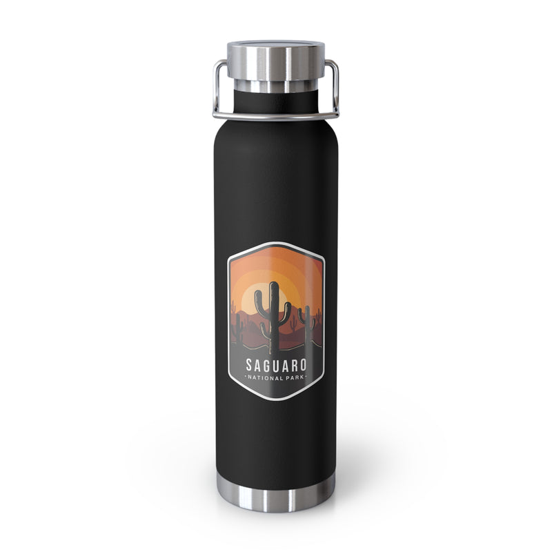 Black stainless steel water bottle featuring a design of Saguaro National Park with cactus and sunset scenery.