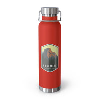 Red stainless steel water bottle featuring a design of Yosemite National Park with a mountain and forest scenery.