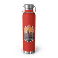 Red stainless steel water bottle featuring a design of Saguaro National Park with cactus and sunset scenery.