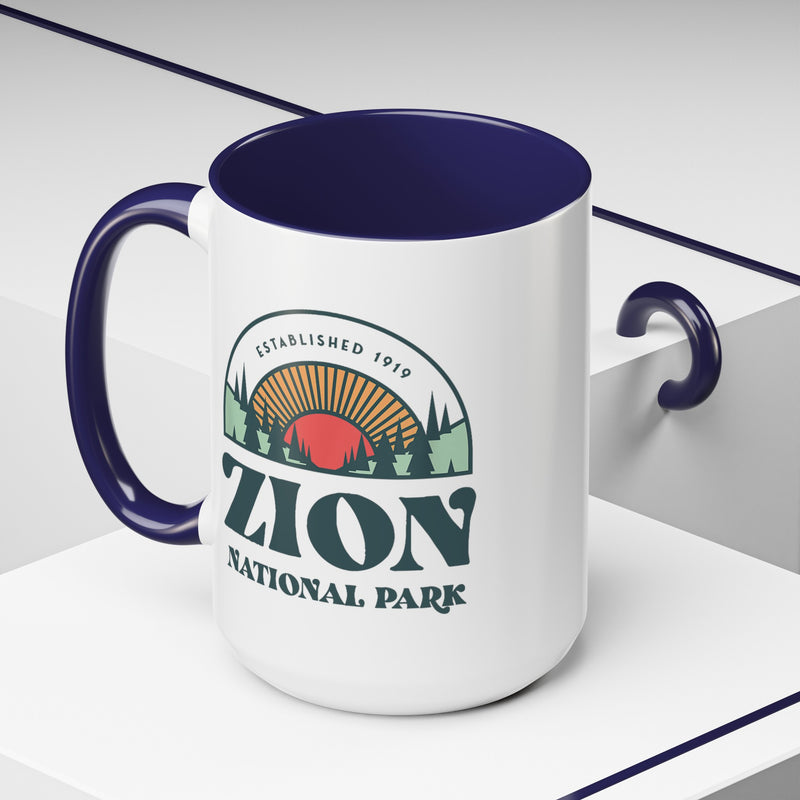 15 oz ceramic mug with navy contrasting handle featuring an established 1919 design of Zion National Park, perfect as a souvenir.