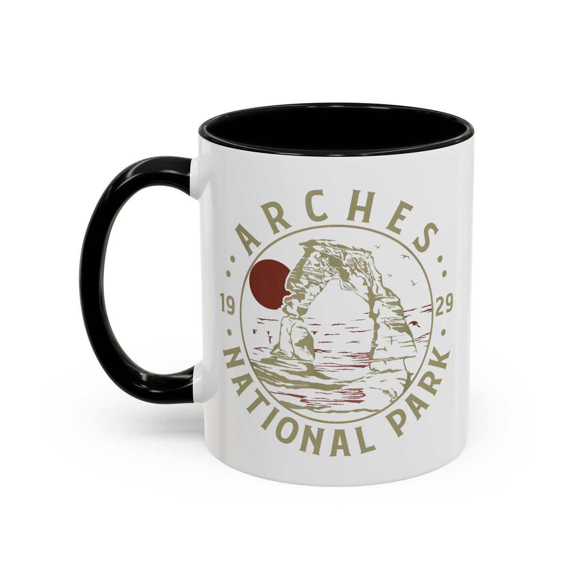 White ceramic mug with a contrasting handle and interior, featuring a design of Arches National Park with Delicate Arch and a sun graphic.