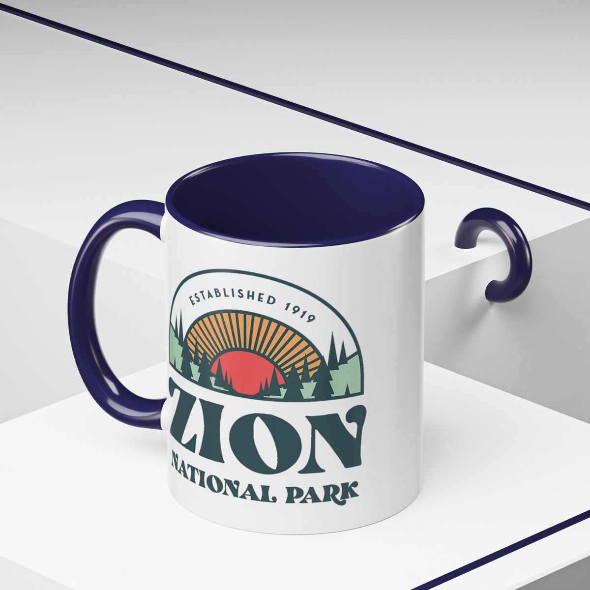 11 oz ceramic mug with navy contrasting handle featuring an established 1919 design of Zion National Park, perfect as a souvenir.