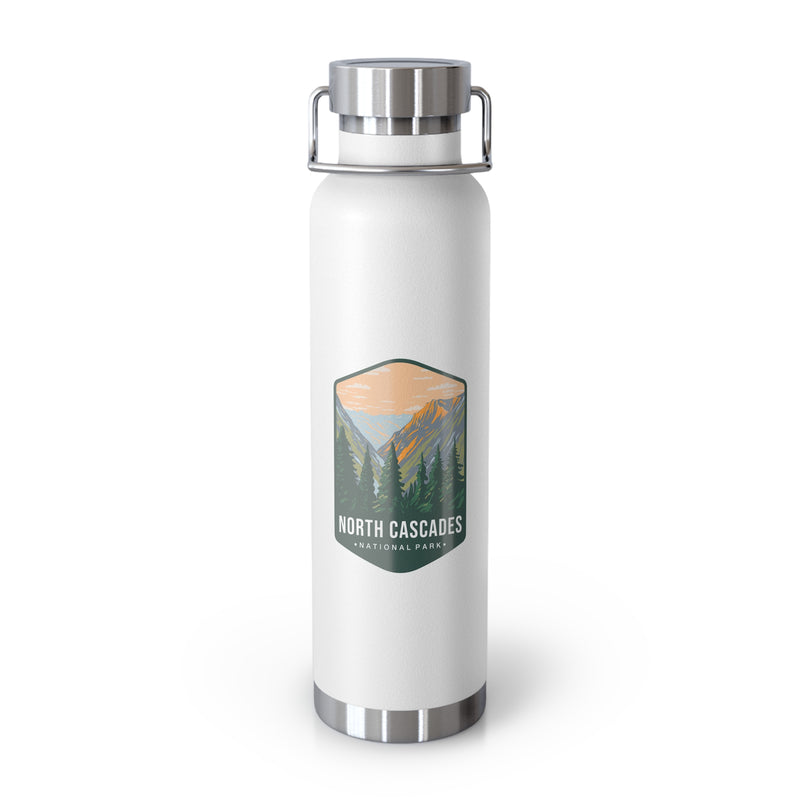 A white double-wall stainless steel water bottle featuring a scenic design inspired by North Cascades National Park, showcasing mountains and pine trees.