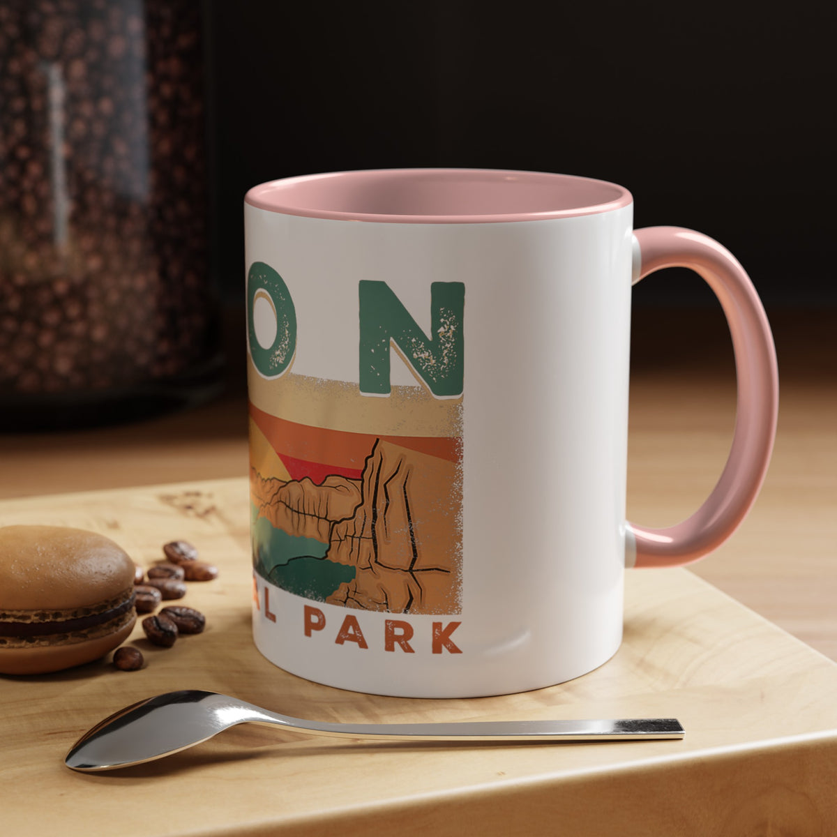 White ceramic mug with contrasting handle and interior, featuring a sunset landscape design of Zion National Park.