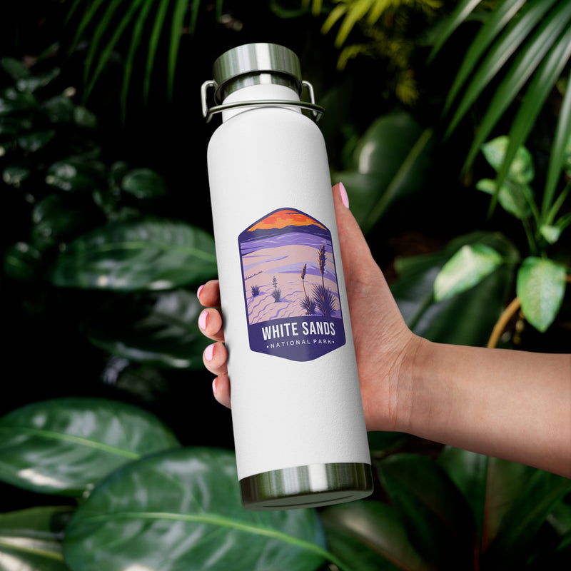 White stainless steel water bottle featuring a design of White Sands National Park with desert and sunset scenery.