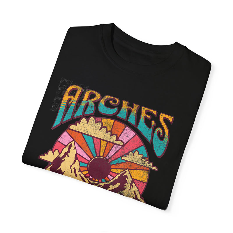 T-shirt featuring a retro scenic design of Arches National Park with a vibrant graphic.