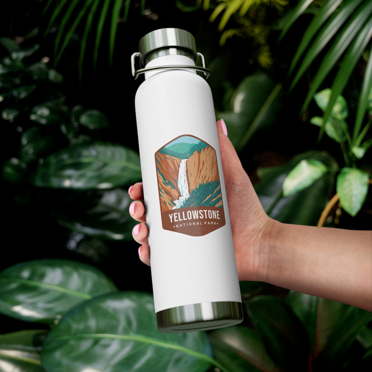 White stainless steel water bottle featuring a design of Yellowstone National Park with a waterfall and canyon scenery.