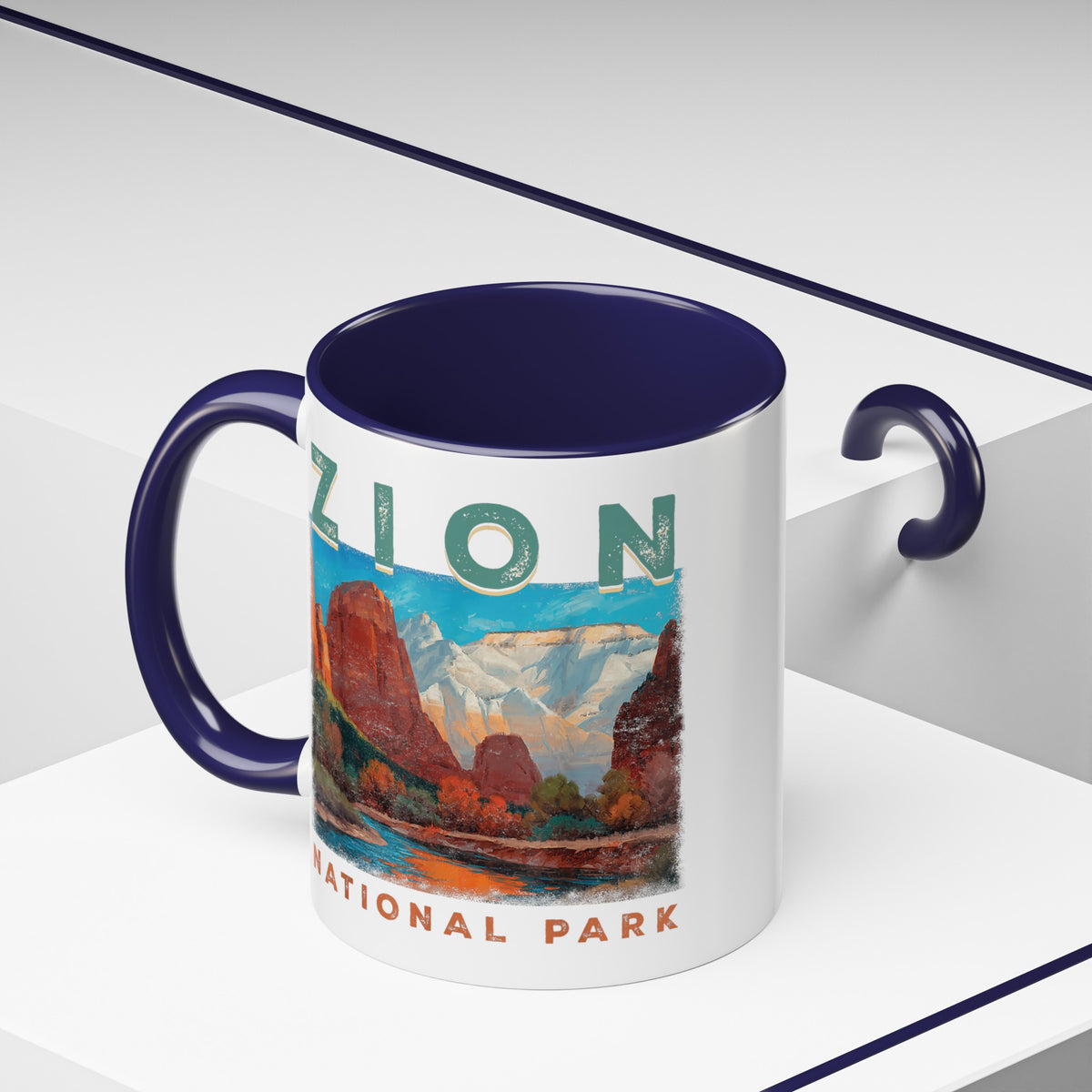 White ceramic mug with a contrasting handle and interior, featuring a scenic landscape design of Zion National Park.