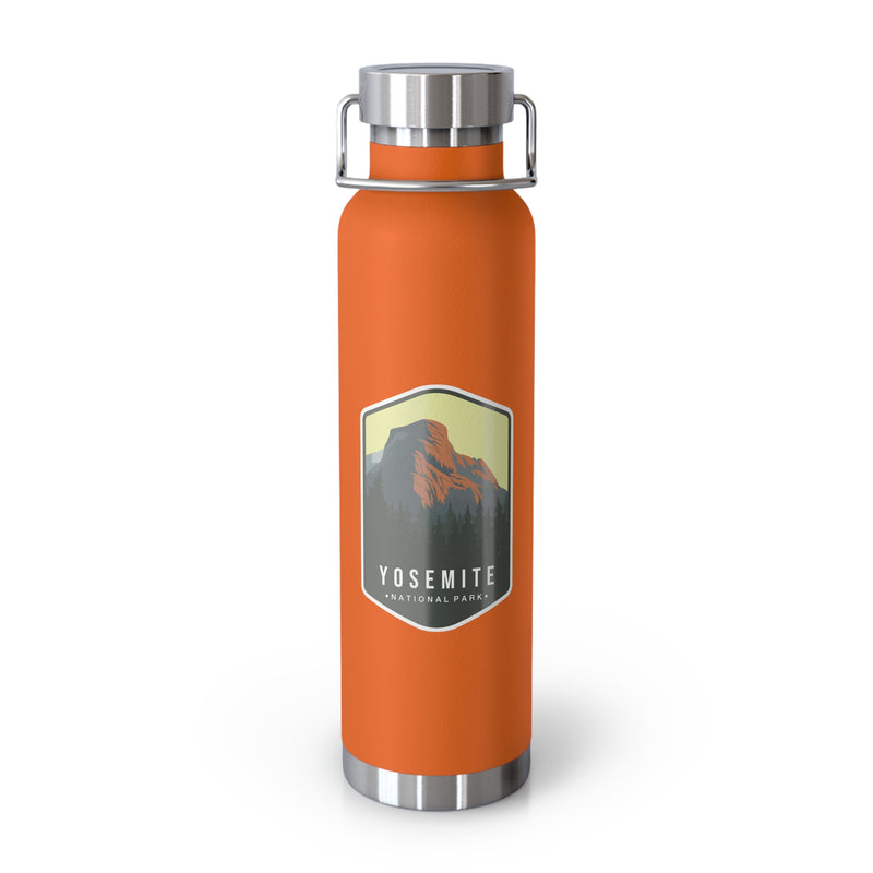 Orange stainless steel water bottle featuring a design of Yosemite National Park with a mountain and forest scenery.