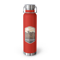 Red stainless steel water bottle featuring a design of Theodore Roosevelt National Park with scenic rock formations.