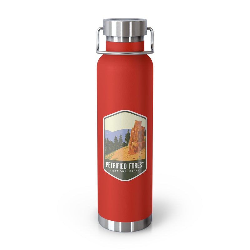 Red stainless steel water bottle featuring a Petrified Forest National Park design with a tall petrified tree.