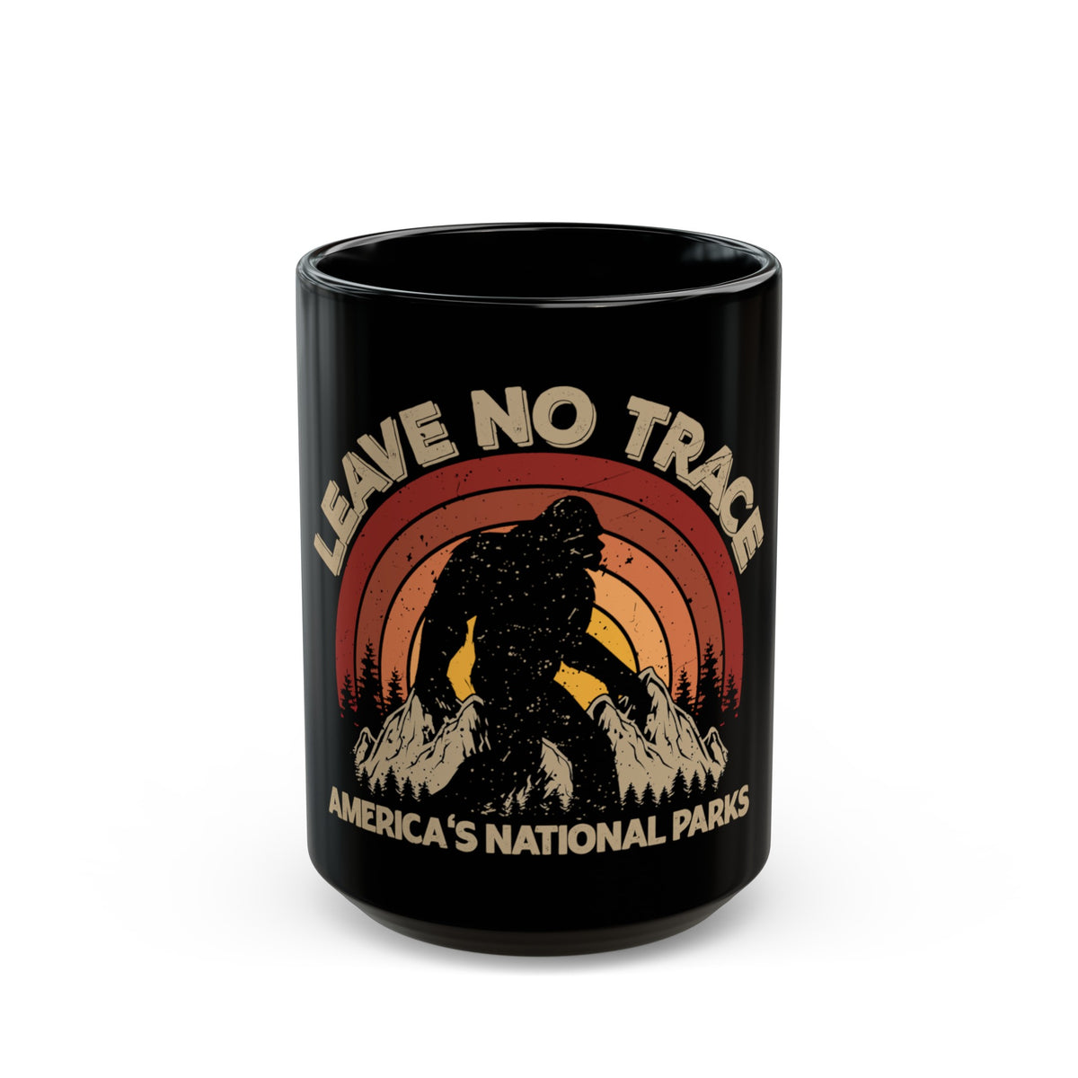 Bigfoot souvenir mug with "Leave No Trace" text and America's National Parks scene featuring a colorful sunset background.