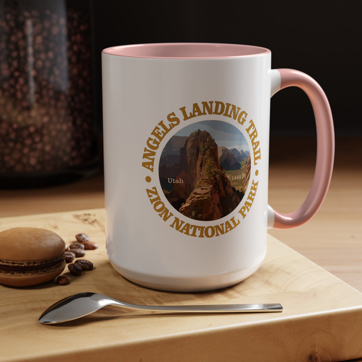 White ceramic mug with a contrasting handle and interior, featuring an image of Angels Landing Trail in Zion National Park with a mountain landscape design.