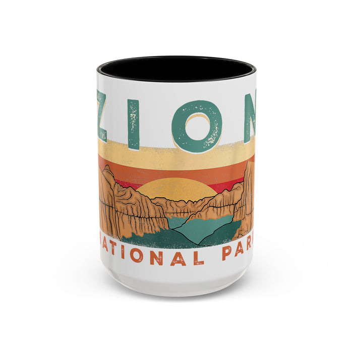 White ceramic mug with contrasting handle and interior, featuring a sunset landscape design of Zion National Park.