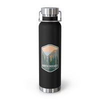 A black double-wall stainless steel water bottle featuring a scenic design inspired by North Cascades National Park, showcasing mountains and pine trees.