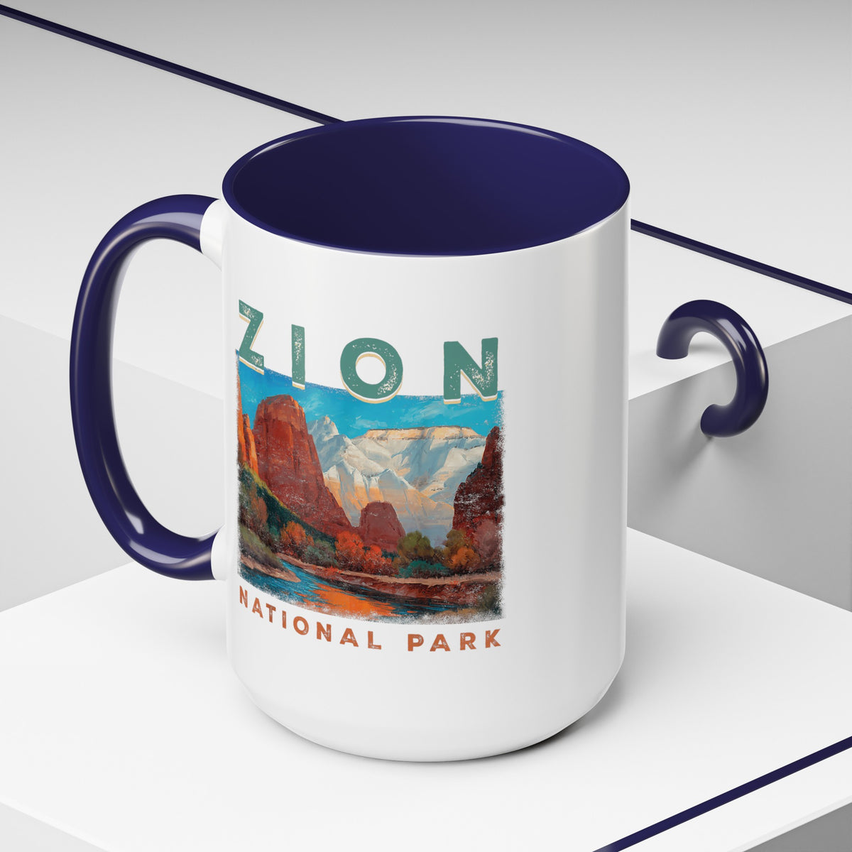 White ceramic mug with a contrasting handle and interior, featuring a scenic landscape design of Zion National Park.