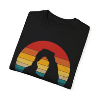 T-shirt featuring a scenic design of Arches National Park in Utah with a prominent arch and sunset background.