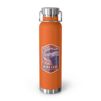 Orange stainless steel water bottle featuring a design of Wind Cave National Park with cave formations.