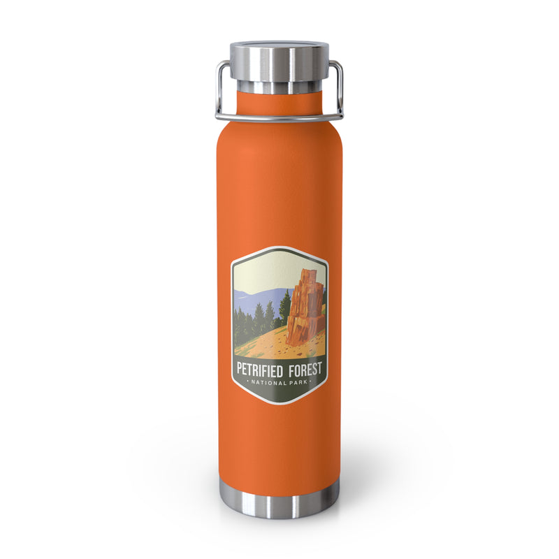 Orange stainless steel water bottle featuring a Petrified Forest National Park design with a tall petrified tree.