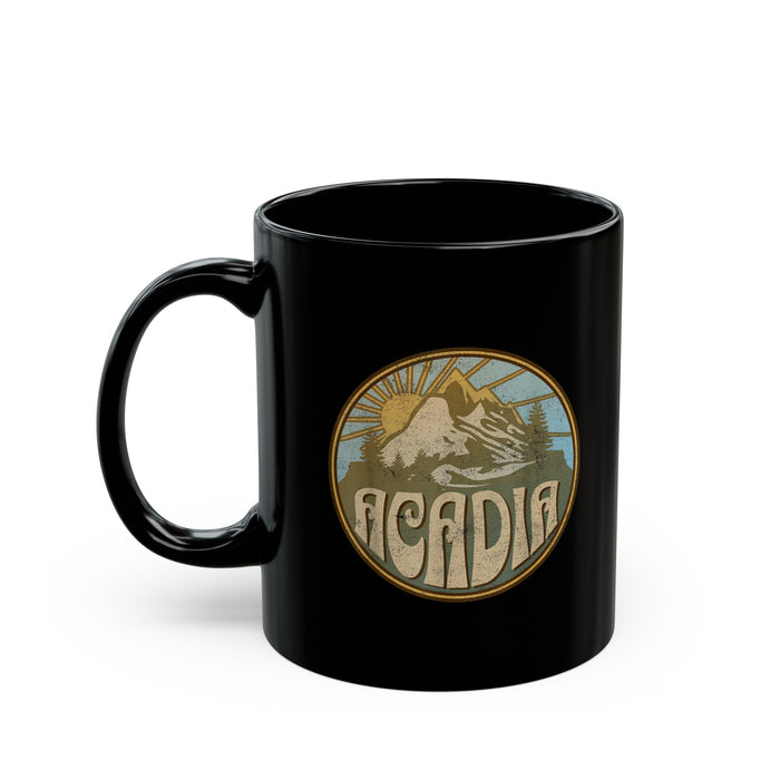 Black ceramic mug featuring a design of Acadia National Park with mountains and a sun graphic.