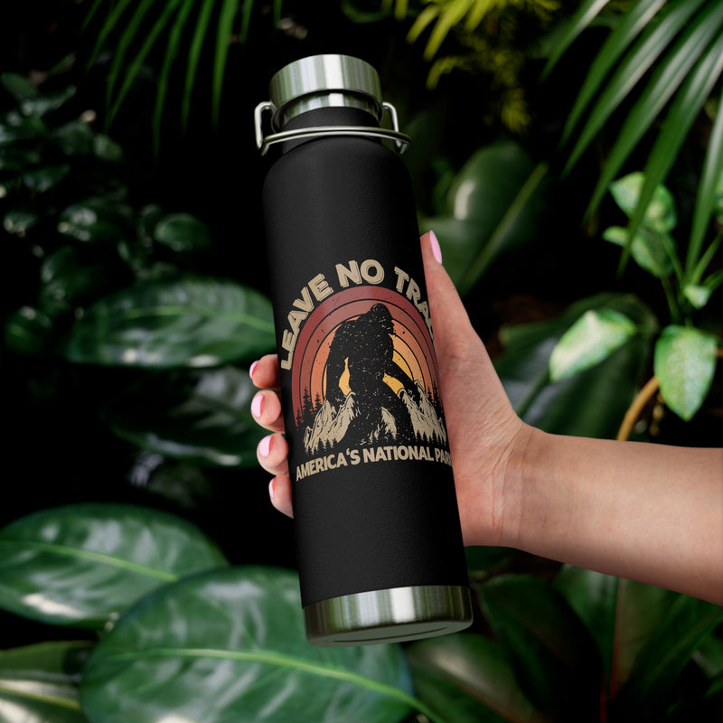 Water bottle featuring a Leave No Trace design with a bear silhouette and sunset background, promoting conservation in America's national parks.