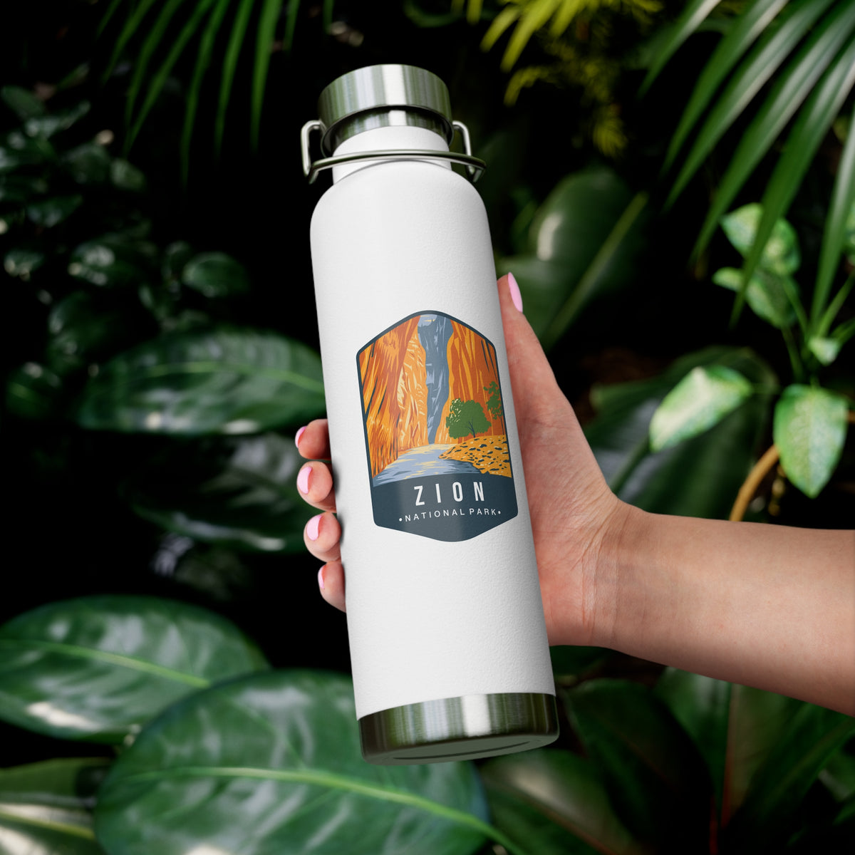 White stainless steel water bottle featuring a design of Zion National Park with a waterfall and canyon scenery.