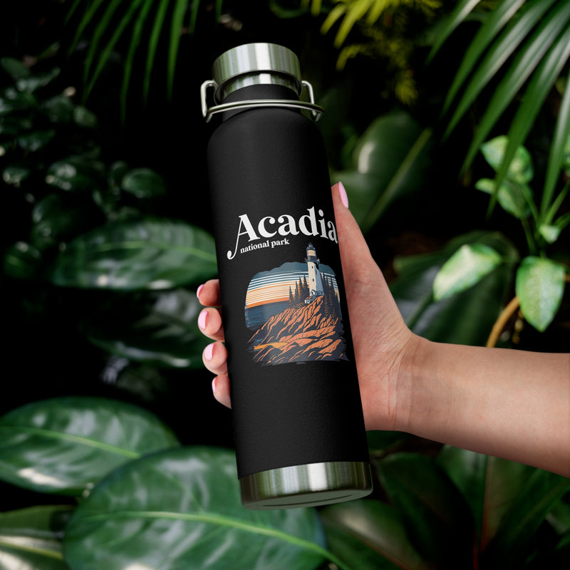 Stainless steel water bottle featuring an Acadia National Park design with a lighthouse and coastal illustration, durable powder-coated finish.