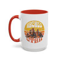 15 oz red ceramic mug with a contrasting handle and interior, featuring a vibrant design of Arches National Park in Utah, showcasing the park's iconic rock formations.