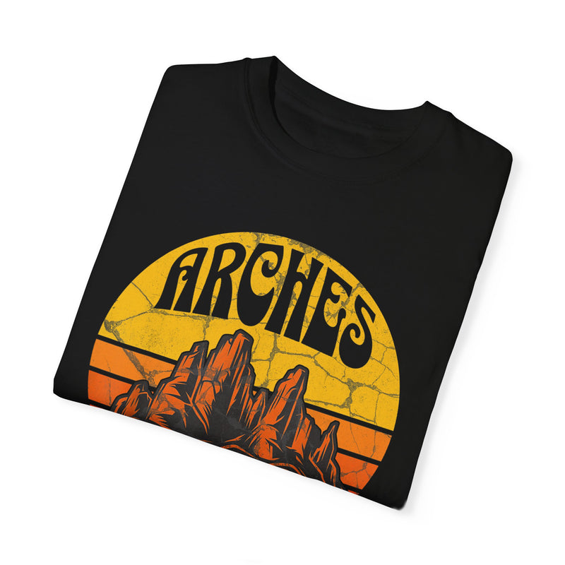 T-shirt featuring a vintage-style design with "Arches Utah" text and a scenic illustration of rock formations.