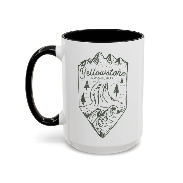 White ceramic mug with a contrasting handle and interior, featuring a minimalist design of Yellowstone National Park with mountains, trees, and a river.